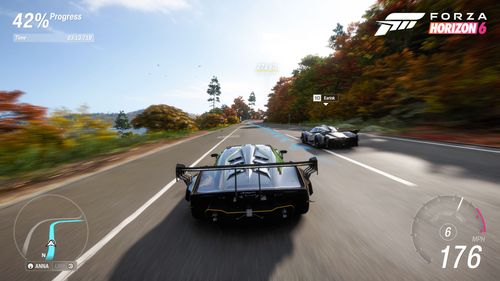 In-game HUD view of a hypercar speeding at 176 MPH down a winding coastal highway in Forza Horizon 6, with autumn trees lining the road.