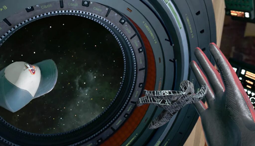 A view through a circular space porthole showing a floating baseball cap and a small, intricate metallic model in zero gravity.