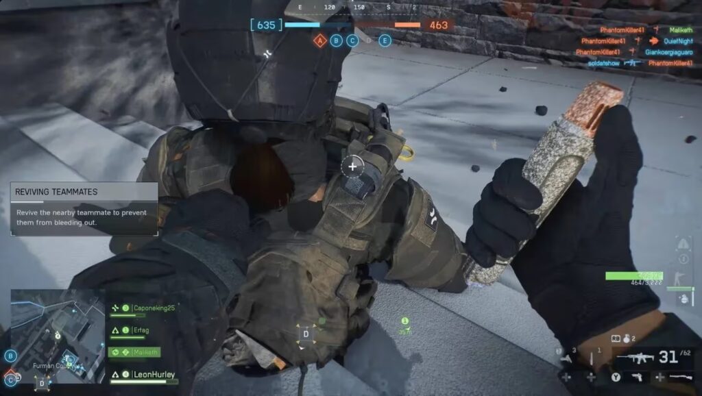 First-person gameplay view in Battlefield 6 showing a player using a defibrillator to revive a downed teammate with a UI notification.